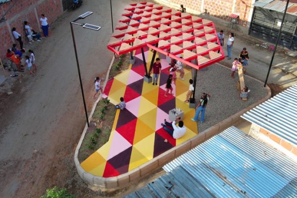 recycled materials transform abandoned triangular lot in colombia into colorful urban space